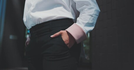 Close up of a cuacasian woman with her hands in her pockets