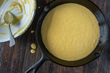homemade cornbread batter in cast iron pan flat lay