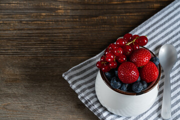strawberries in a bowl on a wooden table.copy space