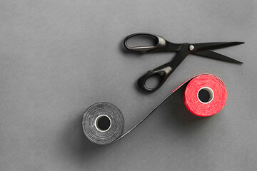 Special physiotherapy tapes and scissors on a colored background. Kinesiology tape treatment, elastic treatment tape Alternative medicine.Copy space	