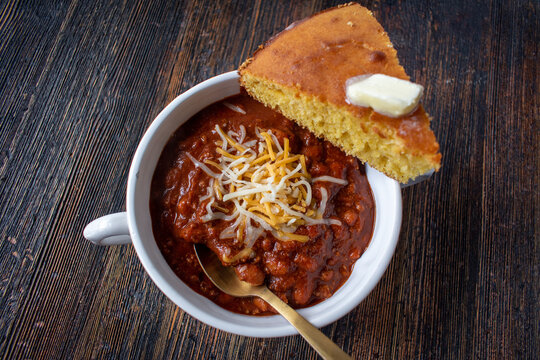 bowl of homemade chili with cornbread top view