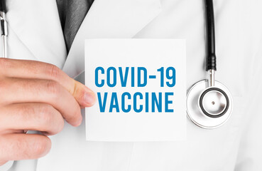 Doctor holding a card with text Covid 19 Vaccine, medical concept