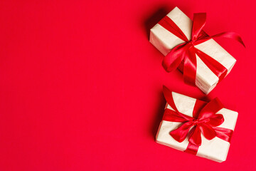 Zero waste gift boxes with festive ribbons on matte rad background