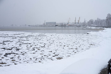 Dark Onega lake in winter, covered with ice