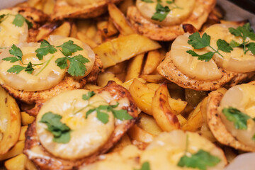 Chicken fillet with pineapple slices of cheese and parsley baked with potatoes in the oven. If the restaurants are closed, the woman prepares a delicious dinner at home for her family