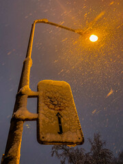 a snowy street sign and a lantern