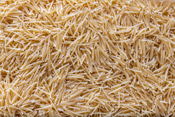 Uncooked vermicelli pasta. Background and texture.