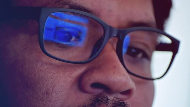The eyes of middle-aged Asian men wearing glasses while working in the office, staring at the computer screen.	
