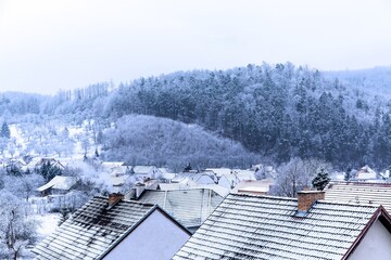Frosty morning in a village in the Czech Republic. View of the frozen roofs of houses. Cold day.