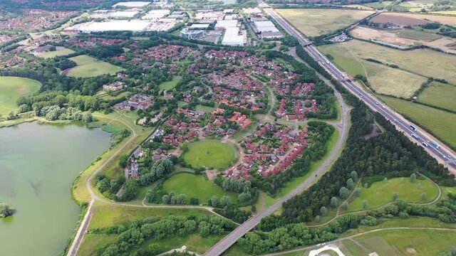 Aerial footage of as typical suburban housing estates in the British town of Milton Keynes north-west of London on a hot sunny summers day