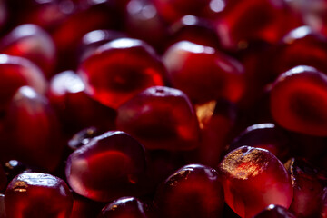 Close-up background texture pattern view of pomegranate fruit seeds.