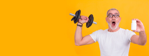 attractive adult man doing sports with dumbbells and in hand with vitamin bottle or food supplement
