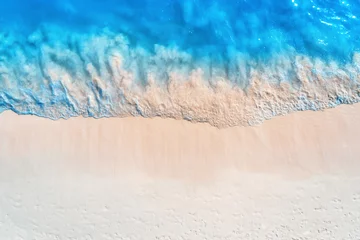 Fotobehang Aerial view of clear blue sea with waves and empty white sandy beach at sunset. Summer in Zanzibar, Africa. Tropical landscape with white sand and azure water. Ocean. Top view. Nature background © den-belitsky