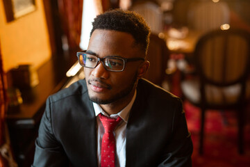 portrait of handsome young african man wearing glasses 