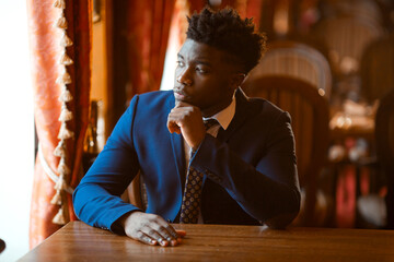 portrait of handsome young african man indoors 