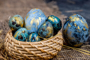 Easter decoration concept: blue painted eggs in a basket close-up