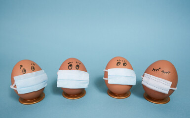 Chicken eggs in medical masks on the face. The concept of the Easter 2021 holiday in relation to...