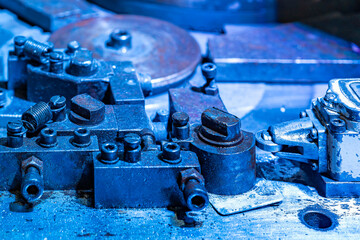 Obraz na płótnie Canvas close up assembly jig or die section unit of bending machine for steel wire or strip plate forming metalwork industrial on blue tone