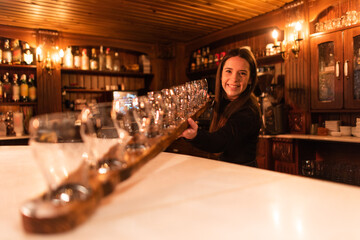 Waiter cowgirl serving drink in a bar