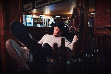Cowboy smoking and drinking in a bar