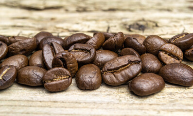 coffee beans on old natural wood background close up