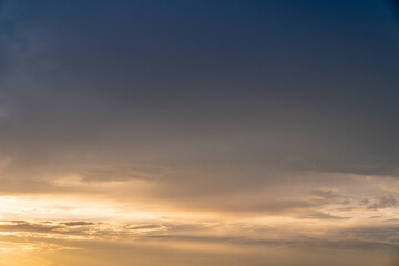 Fototapeta na wymiar Calm dark sunset sky. Yellow and blue colours. Horizontal photo