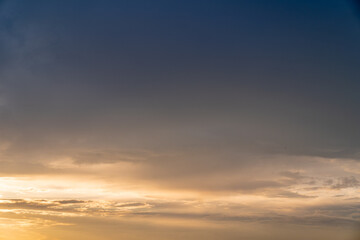 Calm dark sunset sky. Yellow and blue colours. Horizontal photo