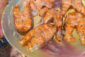 Obraz na płótnie Canvas Grilled red fish trout steaks lie on a glass plate