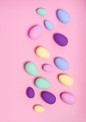Easter eggs colored on a pink background, copy space, flat lay