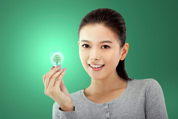 Oriental fashion young female holding a light bulb