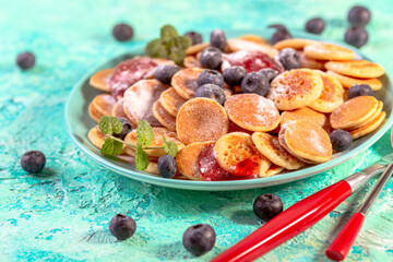 Tiny pancakes with fresh blueberries.