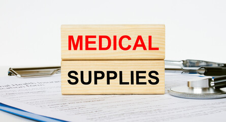 Wooden blocks with text Medical Supplies on a clipboard and a stethoscope