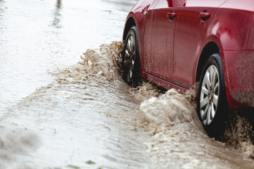 Car stuck in the mud, car wheel in dirty puddle, rough terrain