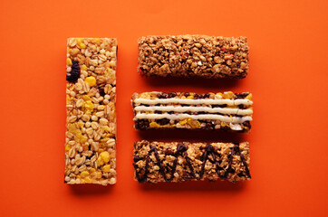 Banner four bars of granola with chocolate fruit and glaze layout on an orange background. High quality photo