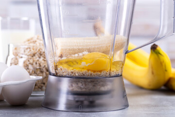 Oats and eggs in a blender. Oat pancakes with banana. Step by step cooking process. Bananas, milk, eggs, oats, salt