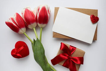 happy valentine's day greeting card mockup. bouquet of red tulips and red heart on white background 
