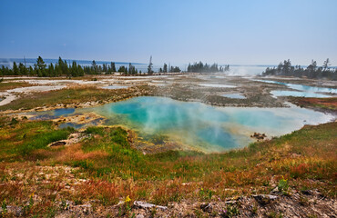 Springs and pools at West Thumb Geyser Basin overlooking Yellowstone Lake. Yellowstone National Park, Wyoming