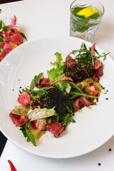 Roast beef with salad mix. Mix of salads, cherry tomatoes, baked pepper, sun-dried tomatoes, roast beef, mustard sauce
