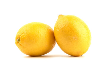 Two whole lemons over a white background.