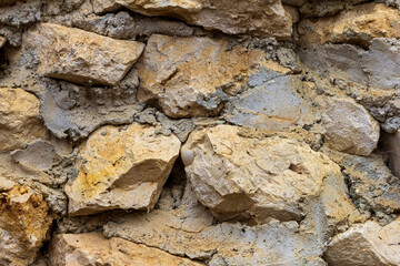 Elements of masonry of a stone wall made of natural stone, with the use of lime mortar.