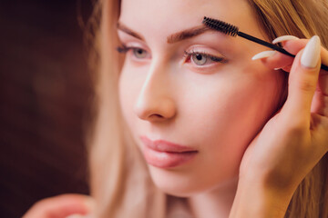 Eyebrows tinting treatment with natural henna dye.