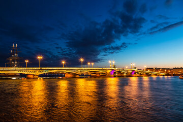 Fototapeta na wymiar White nights in St. Petersburg. View of the Blagoveshchensk (Annunciation) bridge (19th century) across the Neva river. Russia