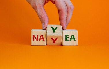 Yea or nay symbol. Businessman turns a cube, changes the word 'nay' to 'yea'. Beautiful orange...
