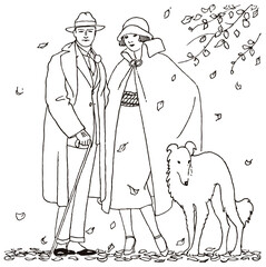 Man and woman from the 20s with their dog waiting in the autumn wind, surrounded by falling leaves