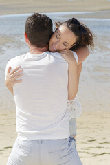 a couple hugging on beach