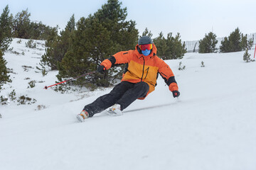 Fototapeta na wymiar Young man skiing in the Pyrenees at the Grandvalira ski resort in Andorra in Covid19 time
