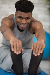 handsome muscular man doing stretching exercise