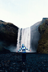 Woman enjoying the view of a waterfall