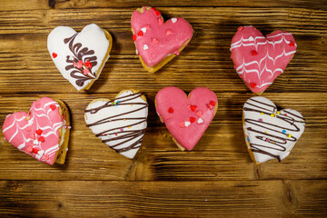 Fototapeta na wymiar Heart shaped cookies on wooden table. Top view. Dessert for Valentine day