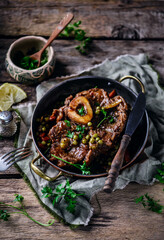 Veal ossobucco with green peas.selective focus